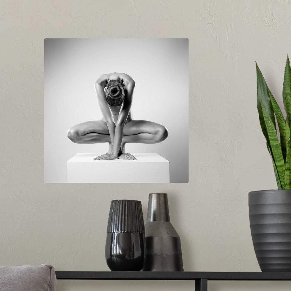A modern room featuring Square high key fine art photograph of a nude woman posing as a sculpture and creating symmetry.