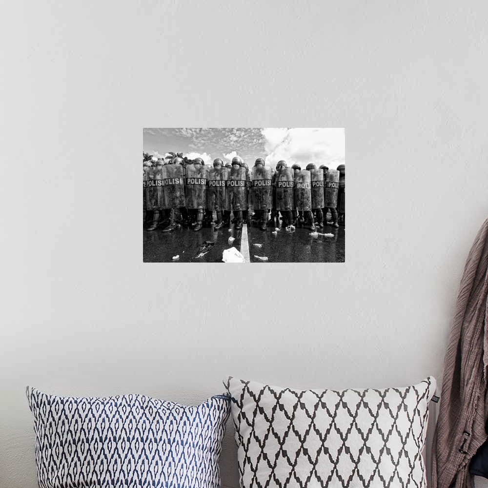 A bohemian room featuring A black and white photograph of a police barricade.