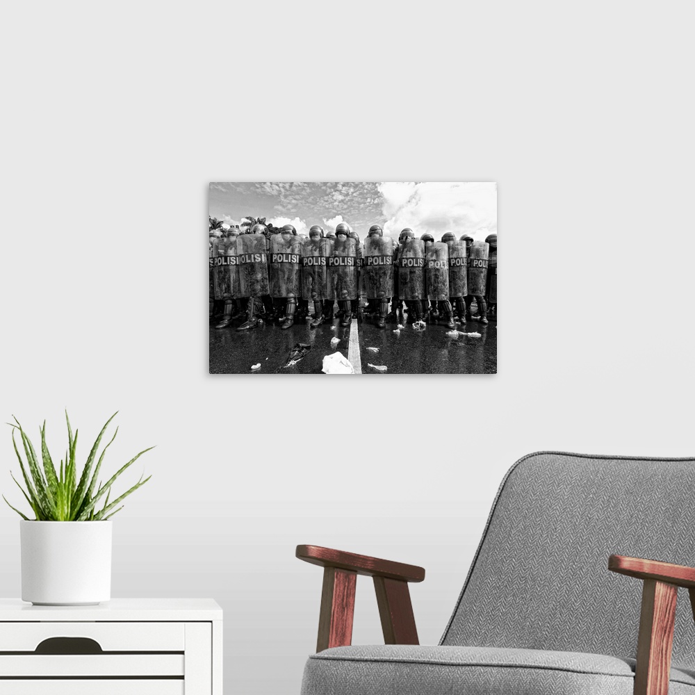 A modern room featuring A black and white photograph of a police barricade.