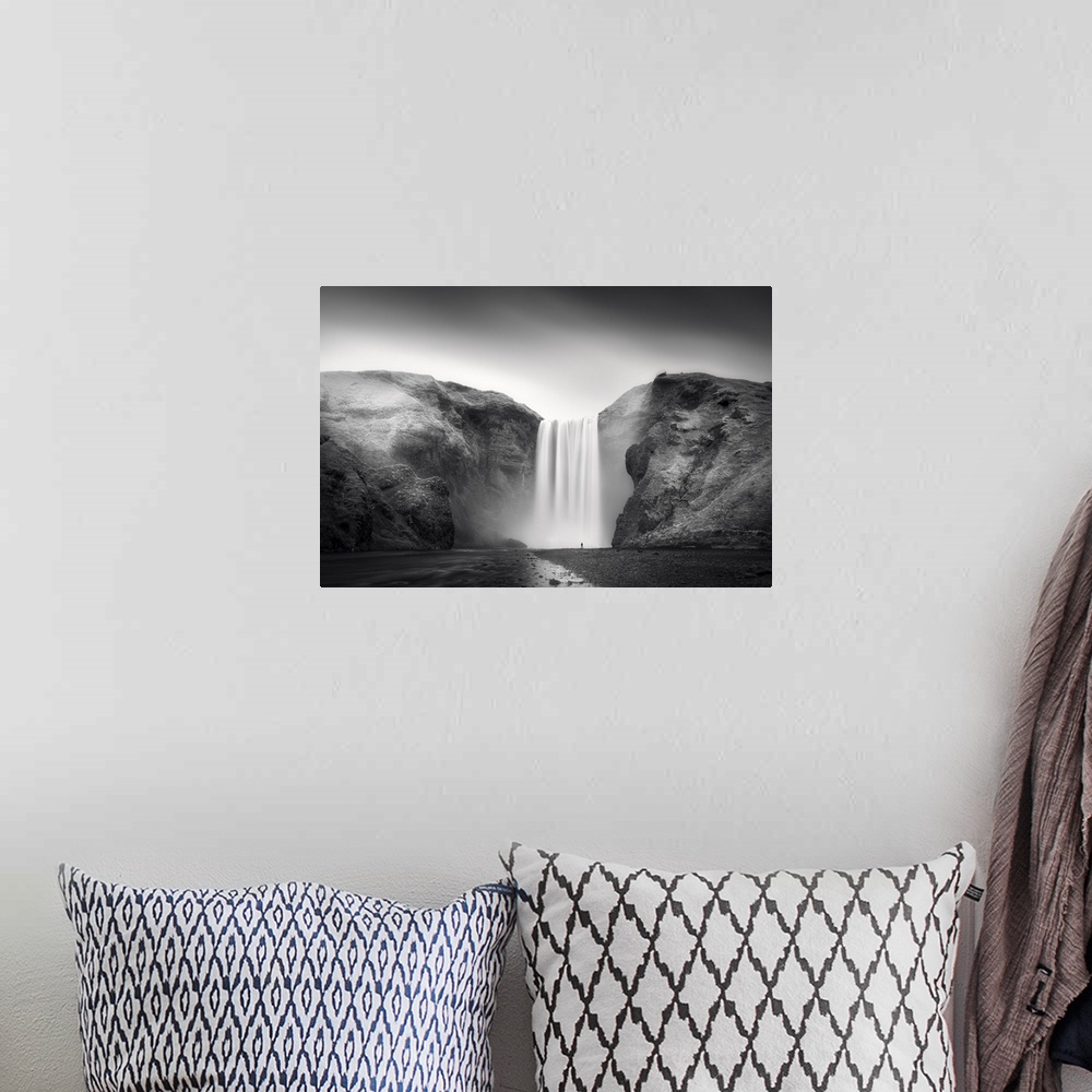 A bohemian room featuring A photograph of an ethereal waterfall in Iceland.