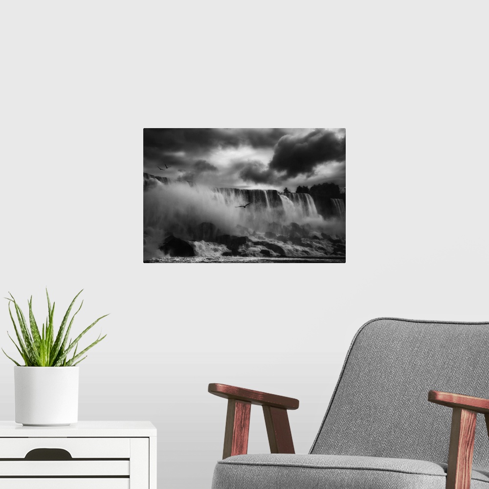 A modern room featuring Birds flying over the mist created by Niagara Falls in New York.