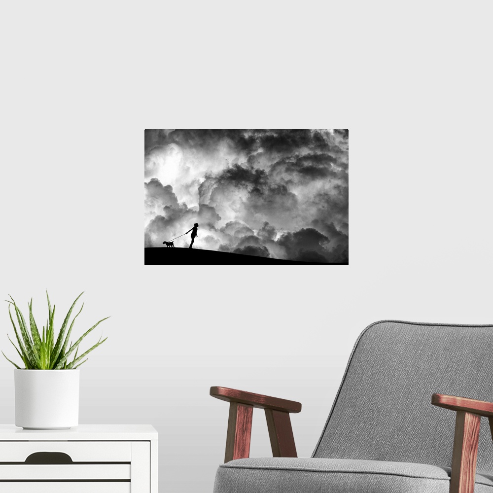 A modern room featuring A girl holding a dog on a leash in silhouette against a background of dramatic clouds.