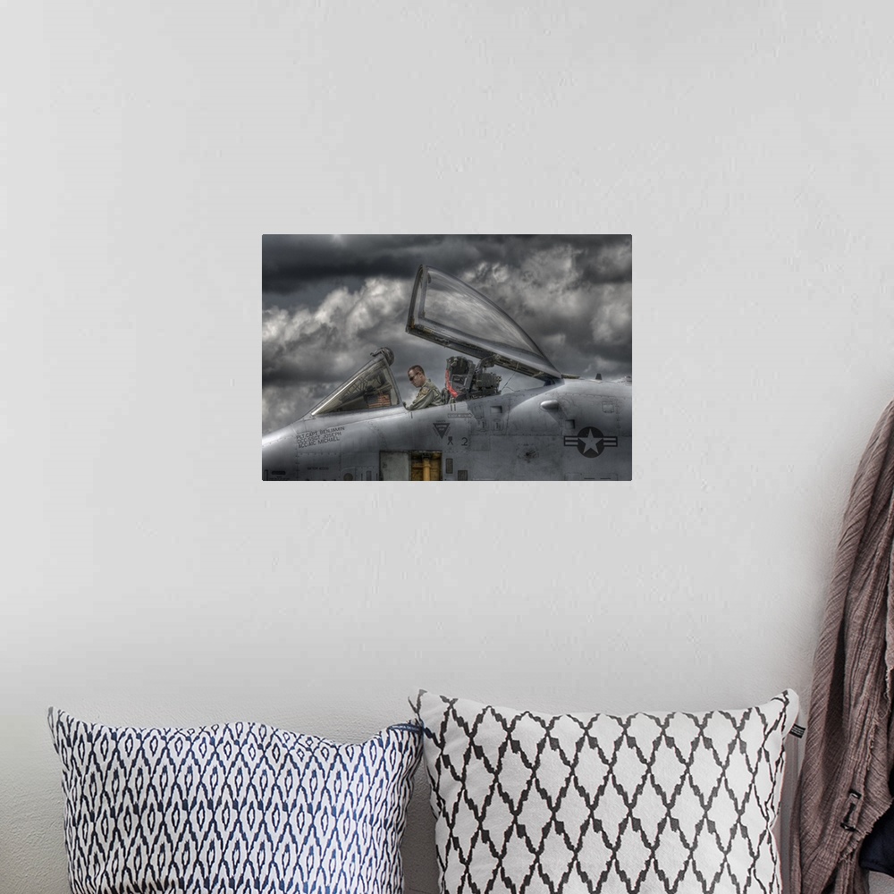 A bohemian room featuring A US Air Force pilot sitting in the cockpit of his plane with dark clouds overhead.