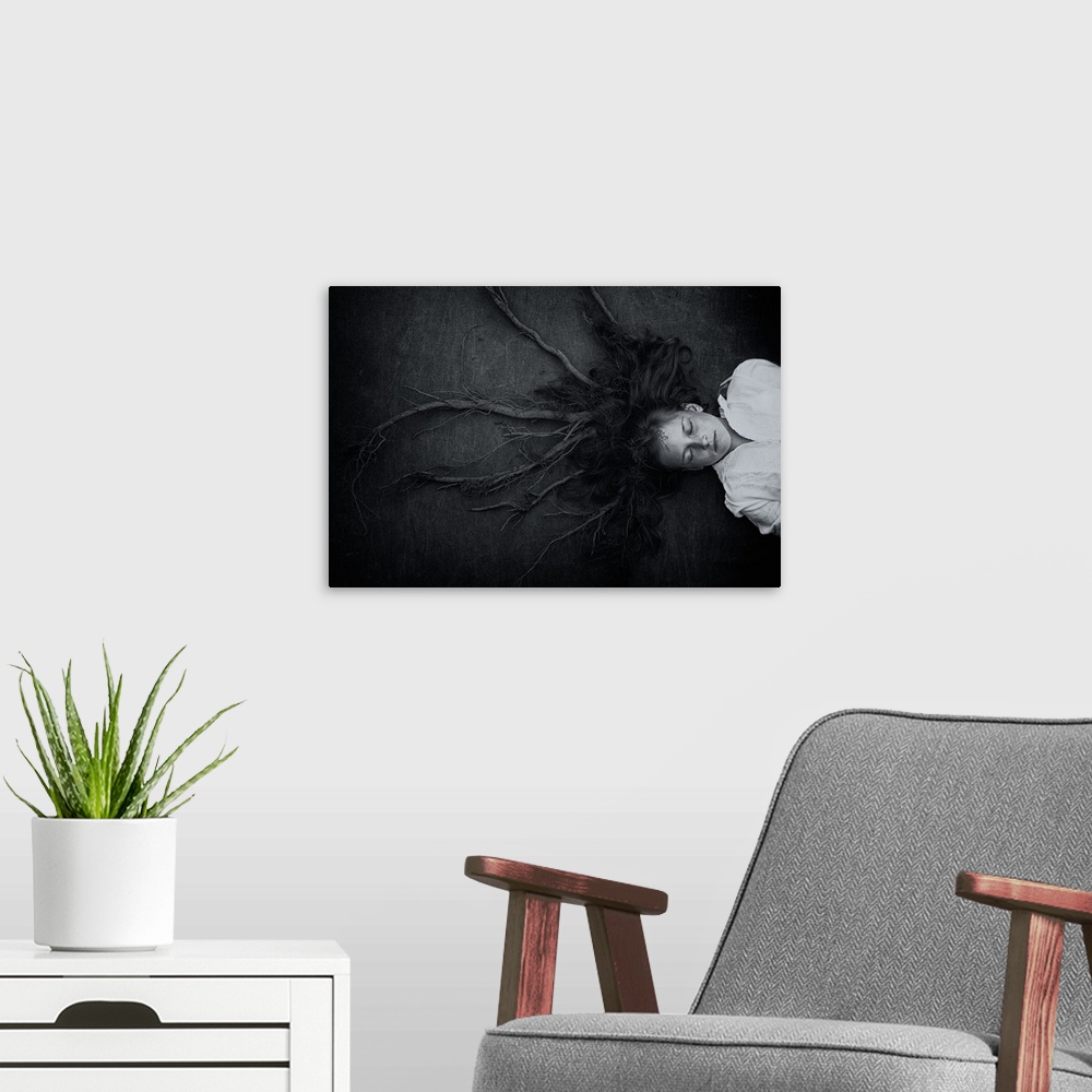 A modern room featuring Conceptual image of a young girl laying on the ground, with her hair transforming into roots.