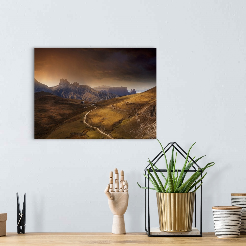 A bohemian room featuring A road winding through the "Denti" mountains in the Dolomite mountains in the Italian Alps.