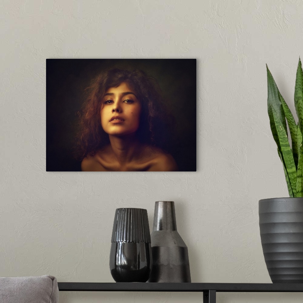 A modern room featuring Portrait of a young woman with tousled curly hair.