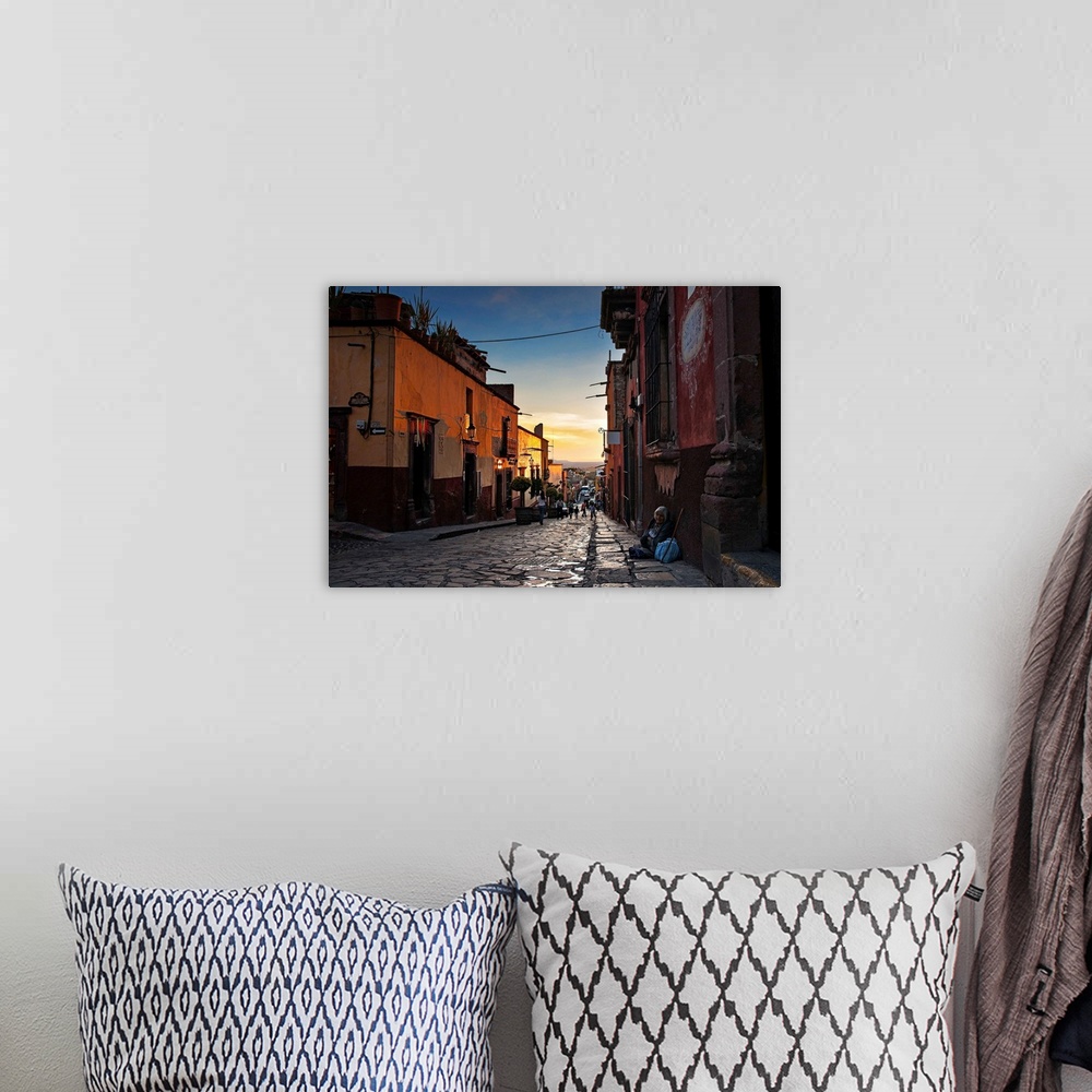 A bohemian room featuring Looking down the street of a Mexican city at dusk.