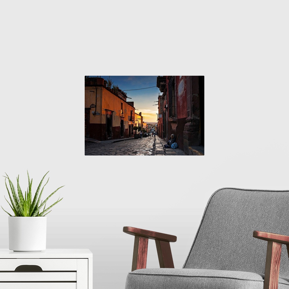 A modern room featuring Looking down the street of a Mexican city at dusk.