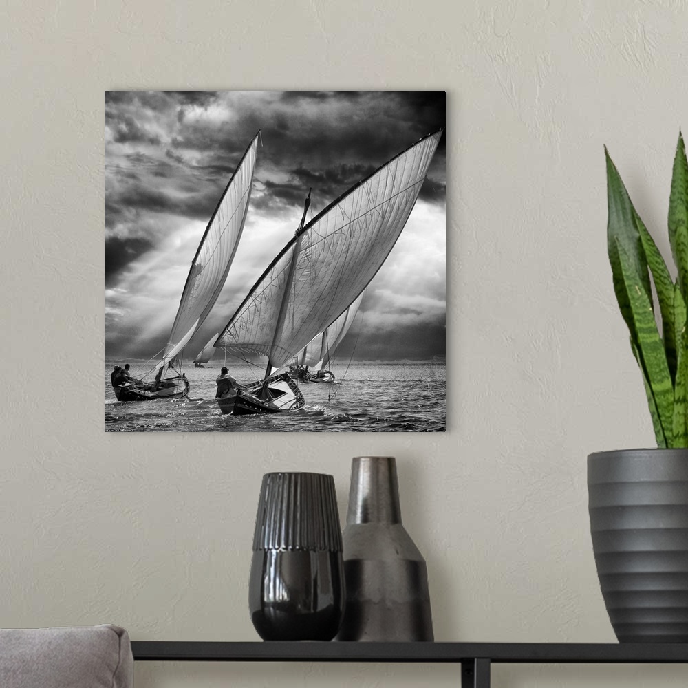 A modern room featuring Black and white image of a fleet of sailboats leaning in the wind under stormy skies.