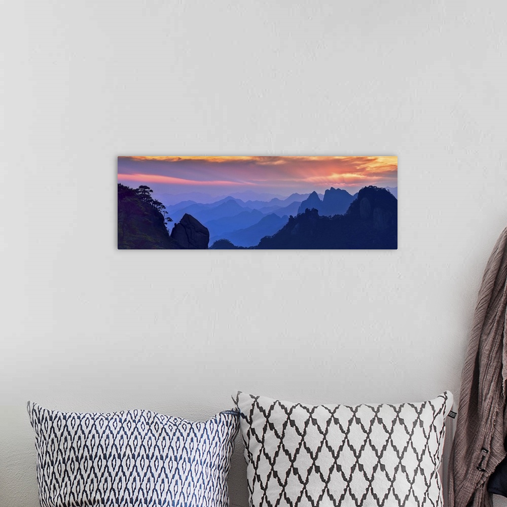A bohemian room featuring Beautiful, colorful panoramic landscape of Mount Sanqing, China at sunset.