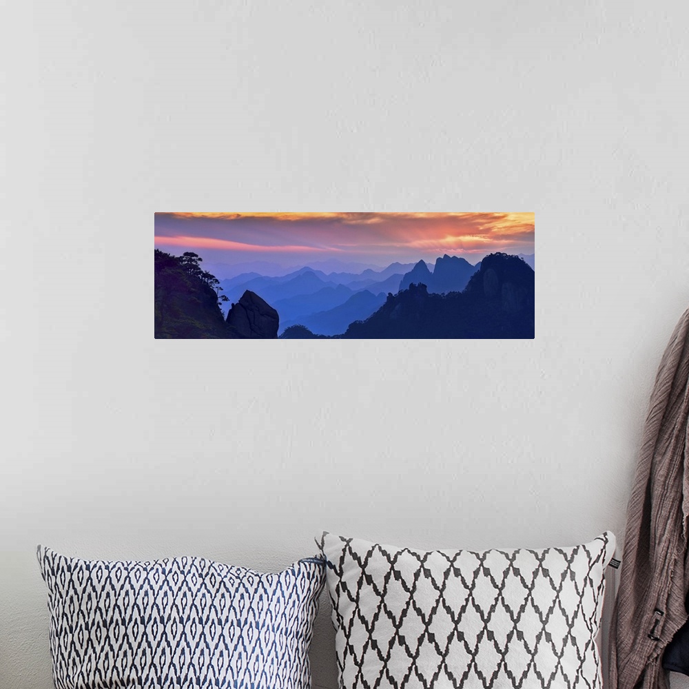 A bohemian room featuring Beautiful, colorful panoramic landscape of Mount Sanqing, China at sunset.