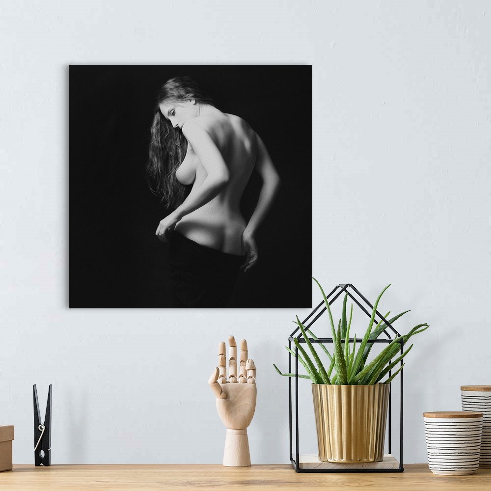 A bohemian room featuring A black and white portrait of nude woman from behind partially exposed.