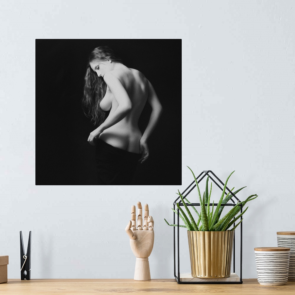 A bohemian room featuring A black and white portrait of nude woman from behind partially exposed.