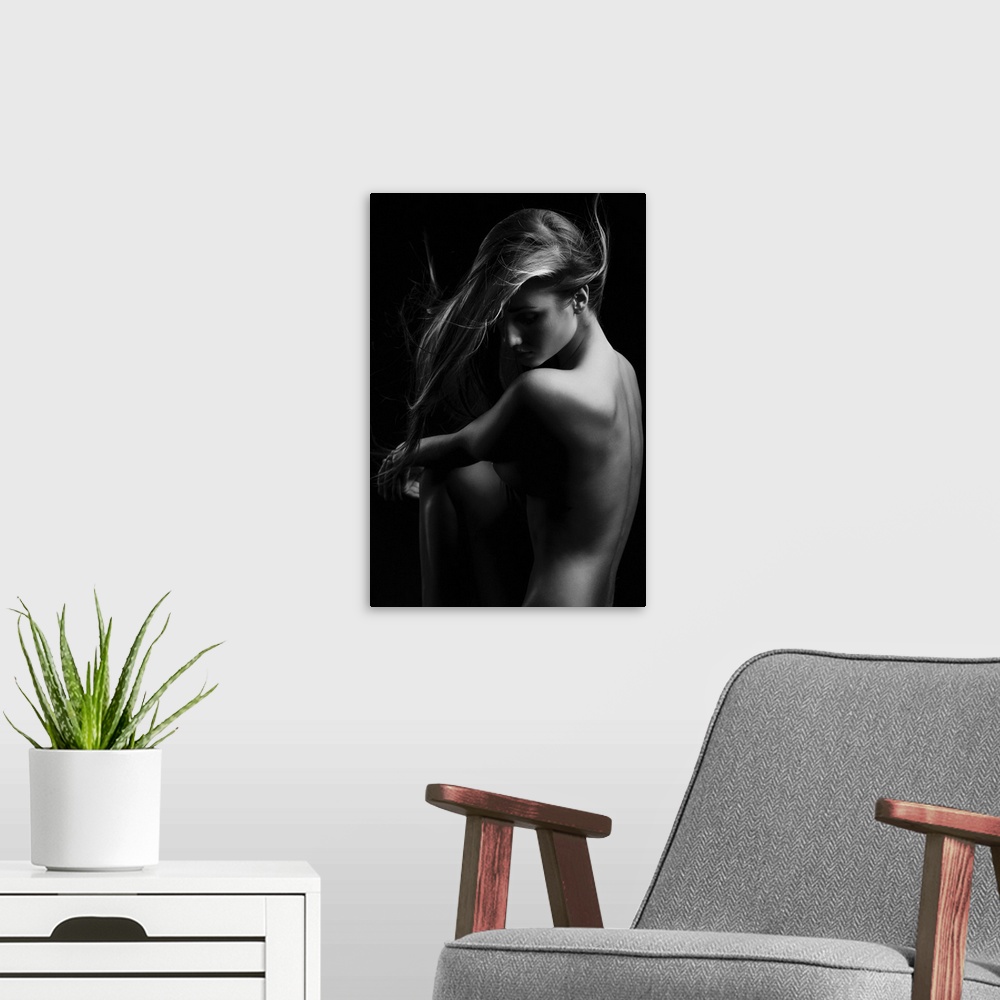 A modern room featuring Black and white portrait of a beautiful nude woman.