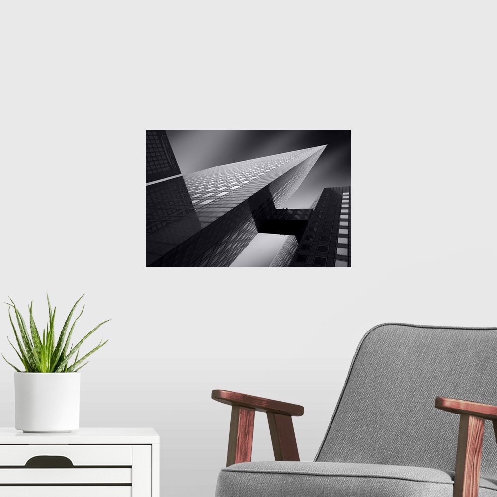 A modern room featuring An abstract photograph of a skyscraper from below.