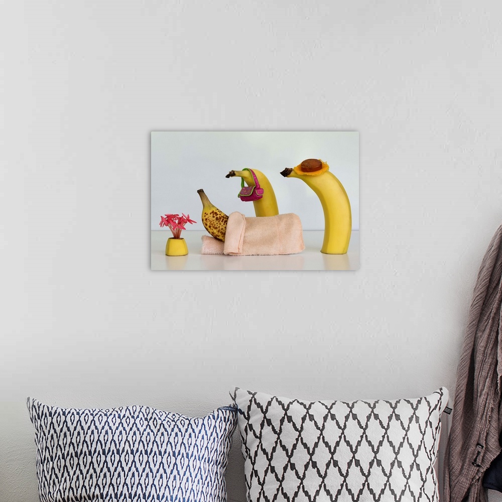 A bohemian room featuring Two bananas tending to another in bed with brown spots.