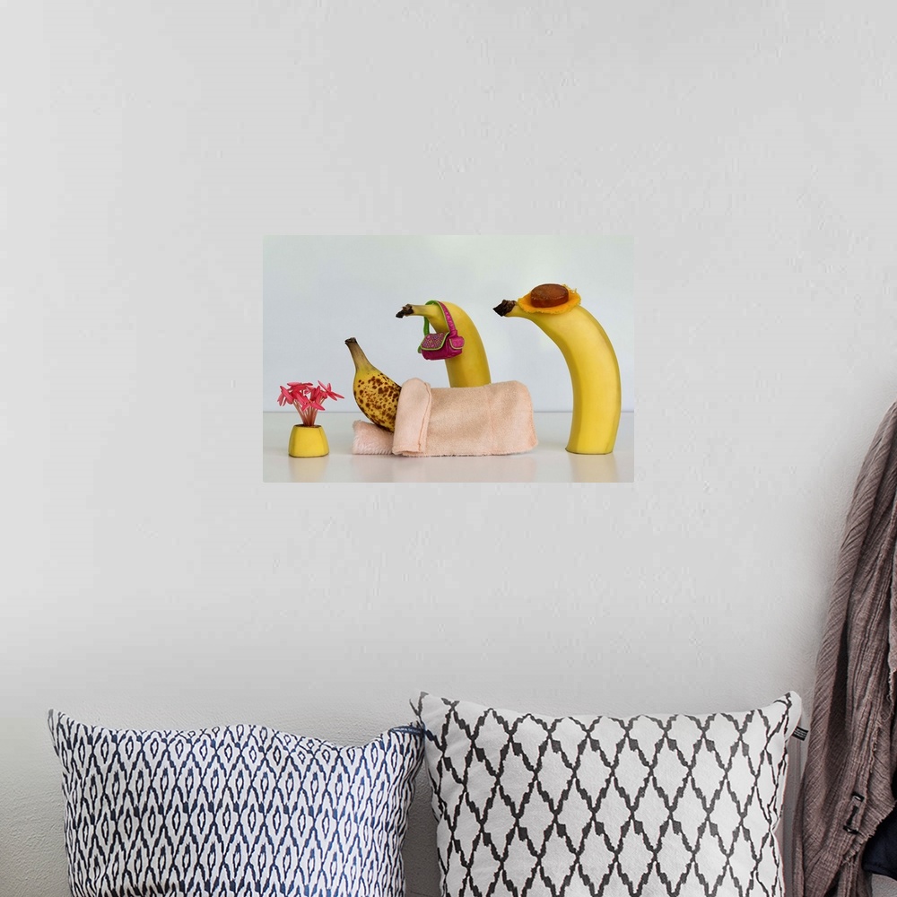 A bohemian room featuring Two bananas tending to another in bed with brown spots.