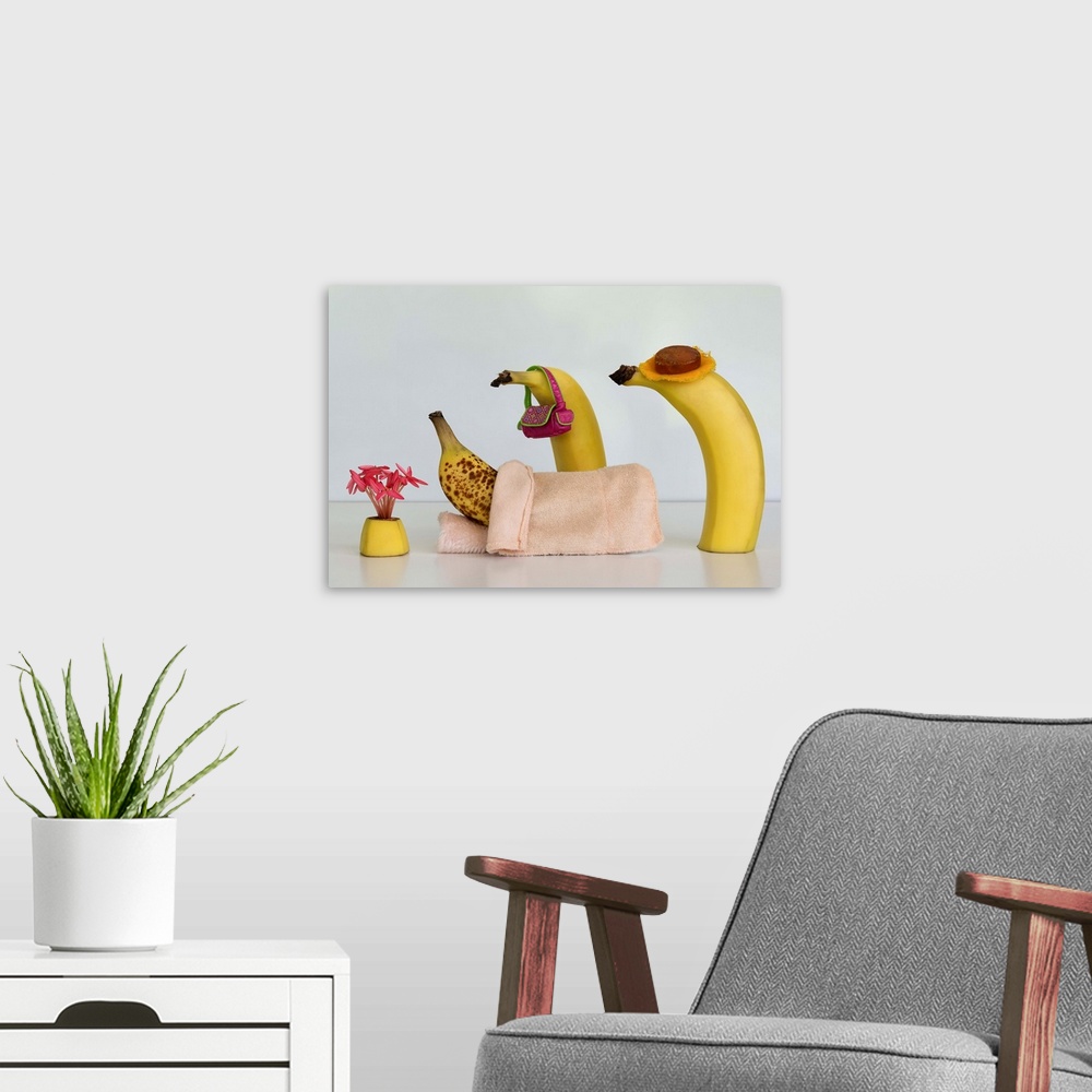 A modern room featuring Two bananas tending to another in bed with brown spots.