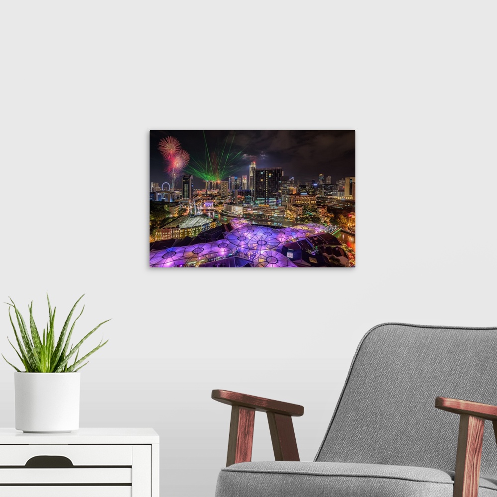 A modern room featuring Laser lights and fireworks display in Singapore at night.
