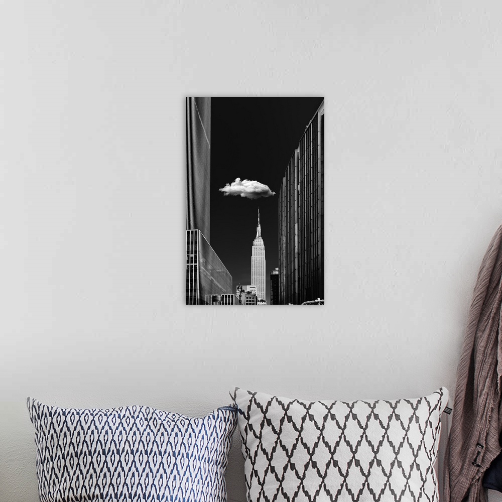 A bohemian room featuring Black and white photograph of a New York City cityscape highlighting the single cloud hanging ove...