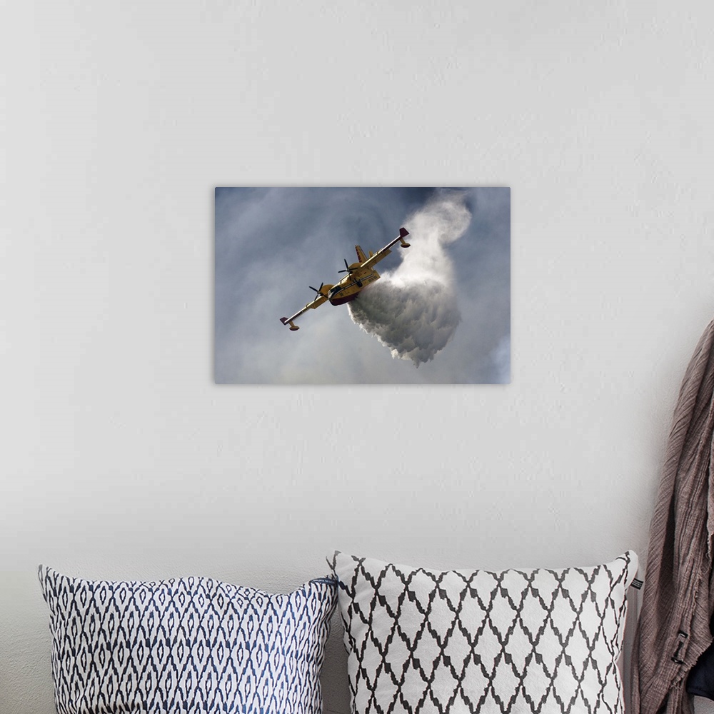 A bohemian room featuring A CanadAir fire plane releasing tons of water in the sky.