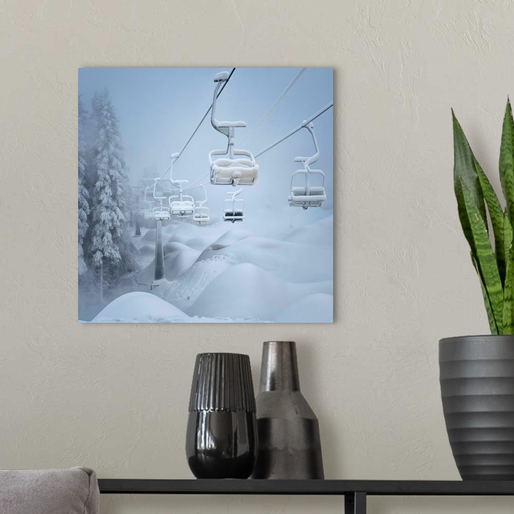 A modern room featuring A ski lift and surrounding landscape covered in snow.