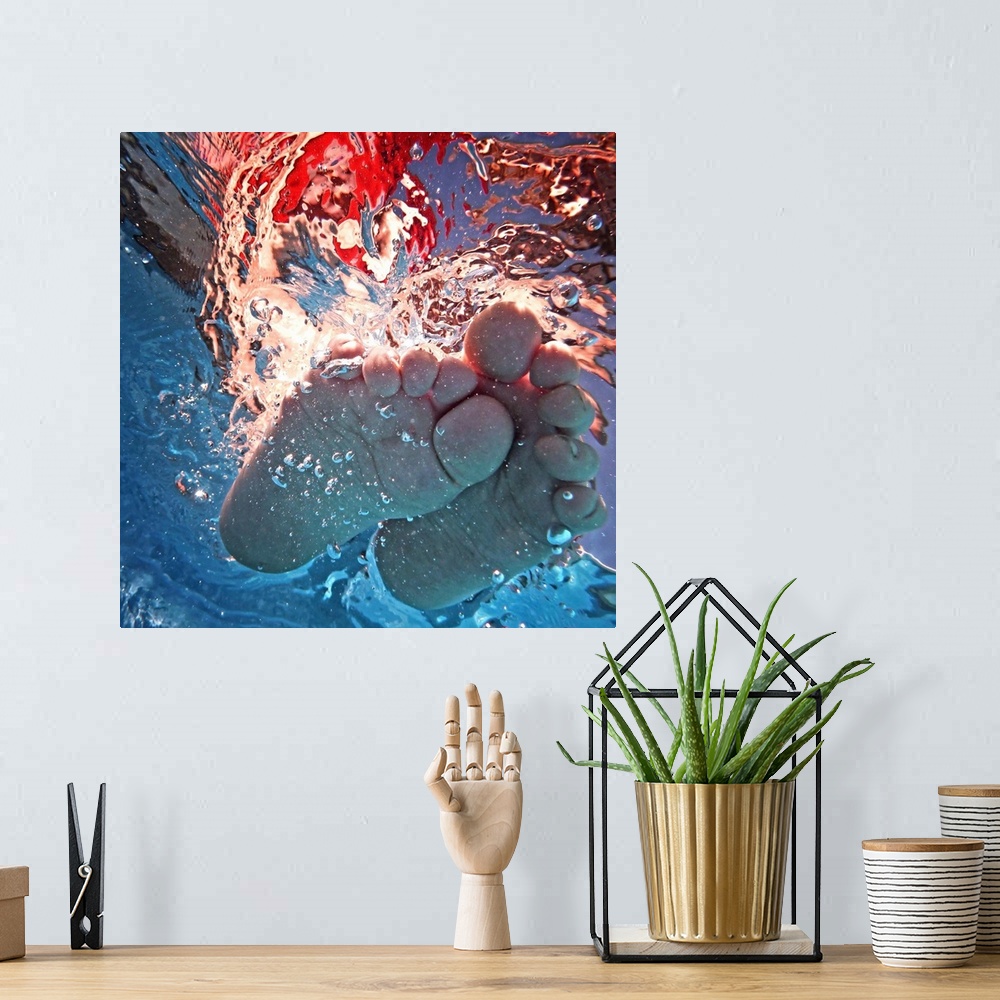 A bohemian room featuring Underwater photograph of a feet splashing around.