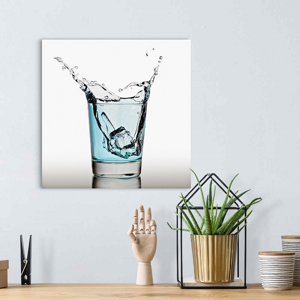 A bohemian room featuring Ice cube splashing in a cool glass of water
