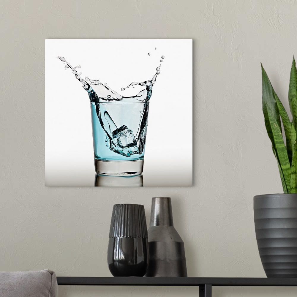 A modern room featuring Ice cube splashing in a cool glass of water