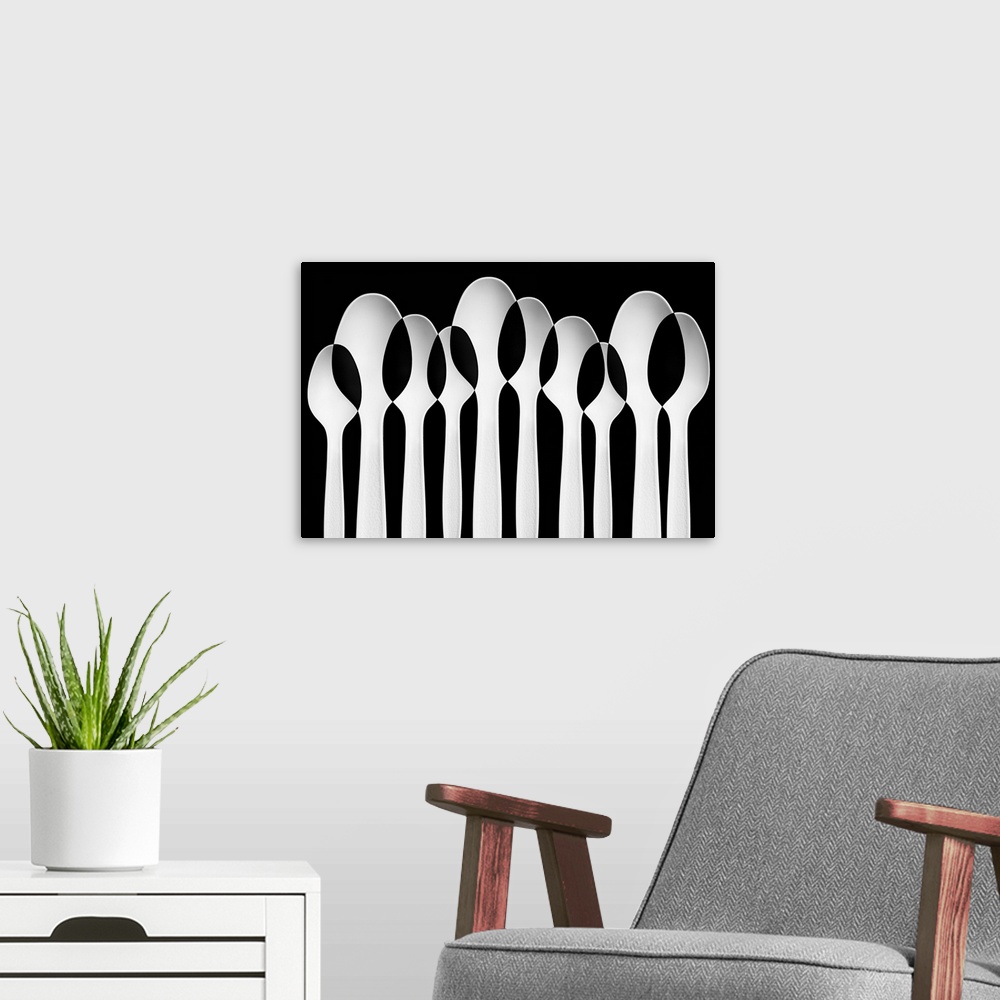 A modern room featuring Spoons standing in a row, with negative space where they intersect.
