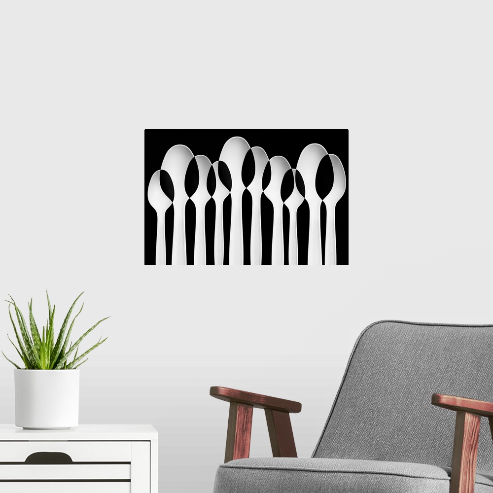 A modern room featuring Spoons standing in a row, with negative space where they intersect.