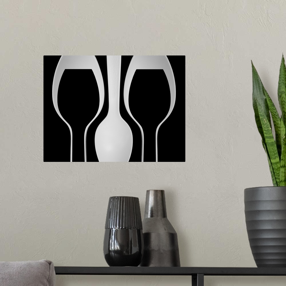 A modern room featuring Abstract image of plastic spoons arranged to resemble wine glasses.