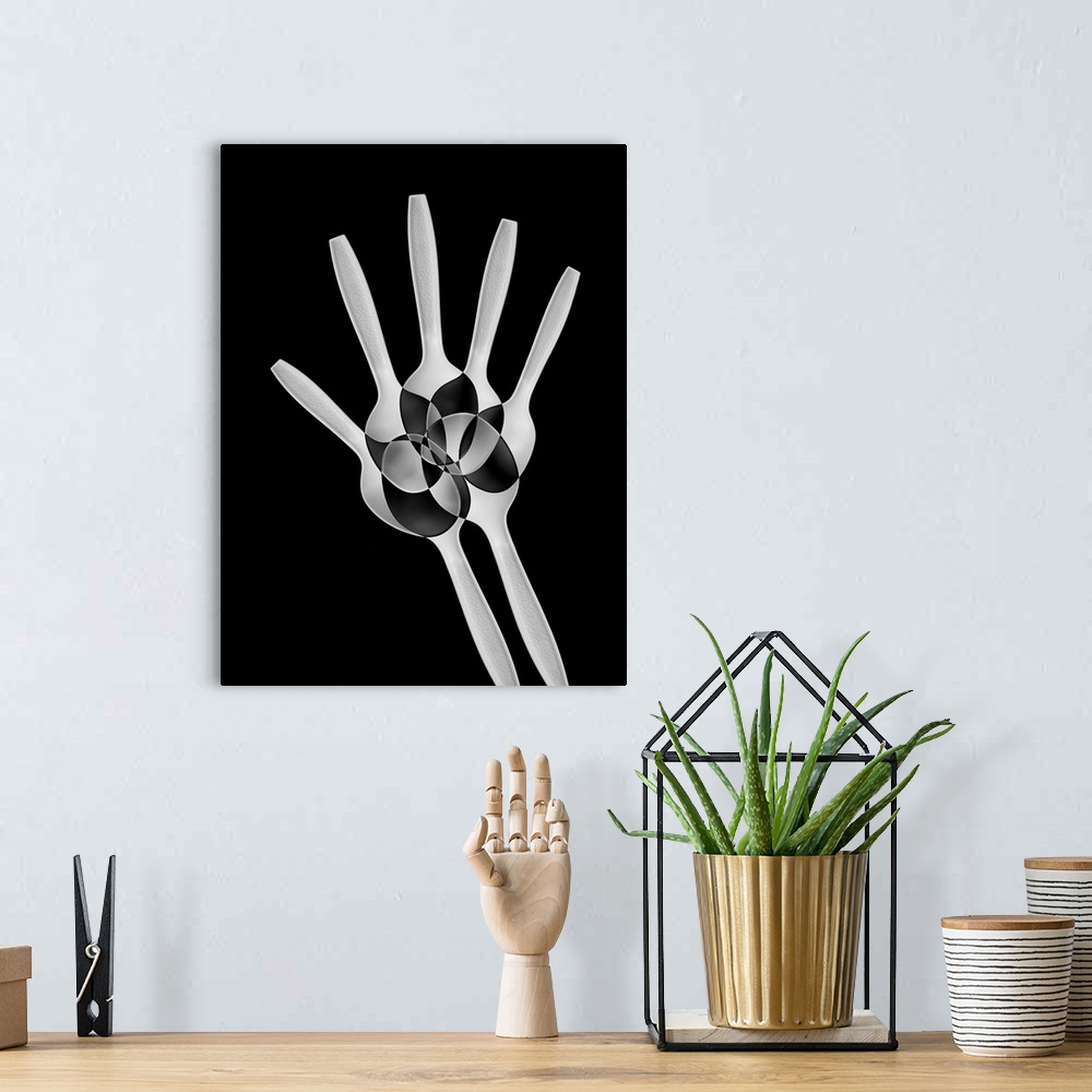 A bohemian room featuring Abstract image of plastic spoons arranged to resemble the bones of a hand.