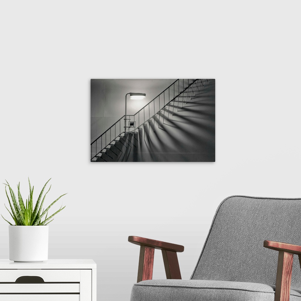 A modern room featuring A streetlight casting abstract shadows on a staircase on a building in the Netherlands.
