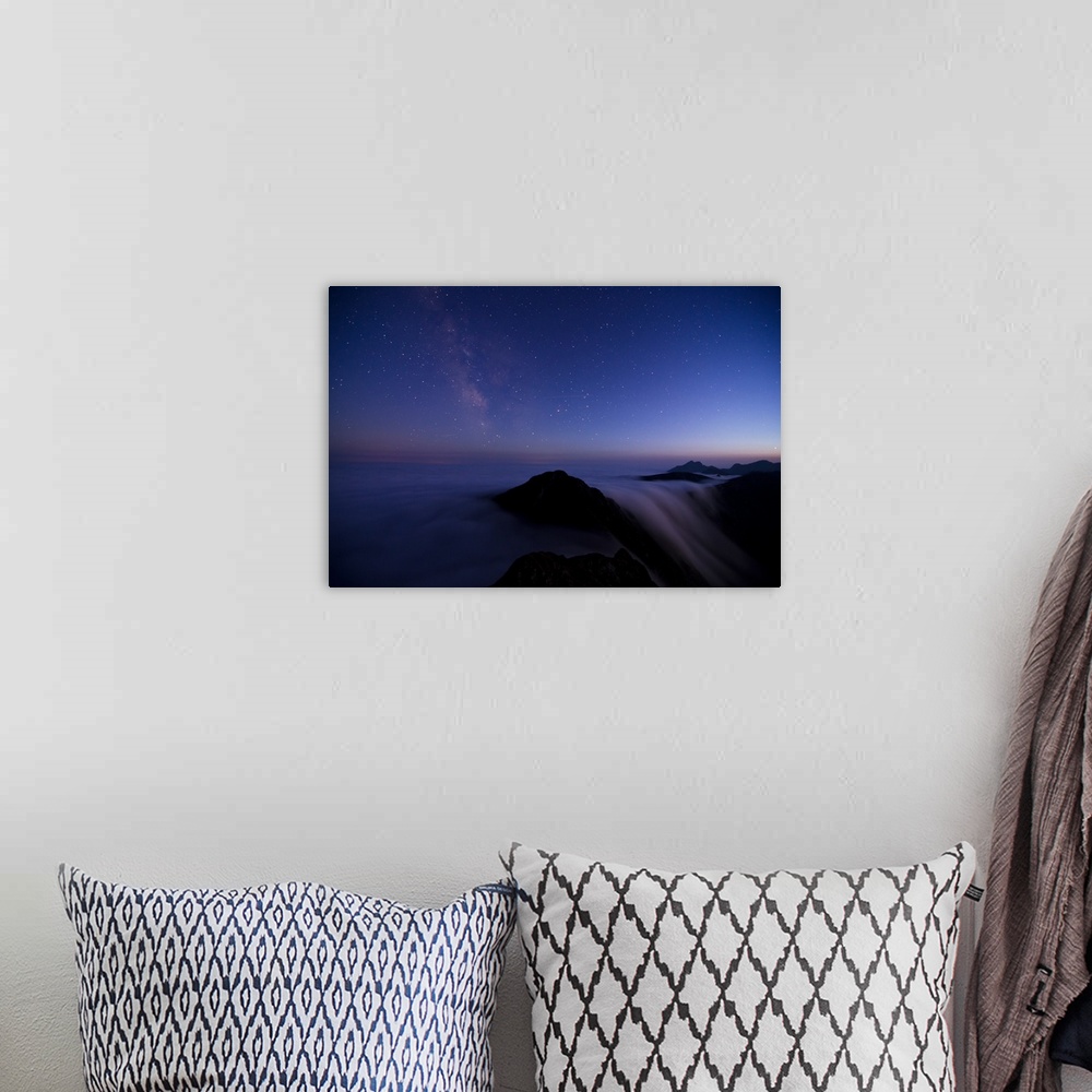 A bohemian room featuring Skyscape in the evening with stars, above a misty mountain range.