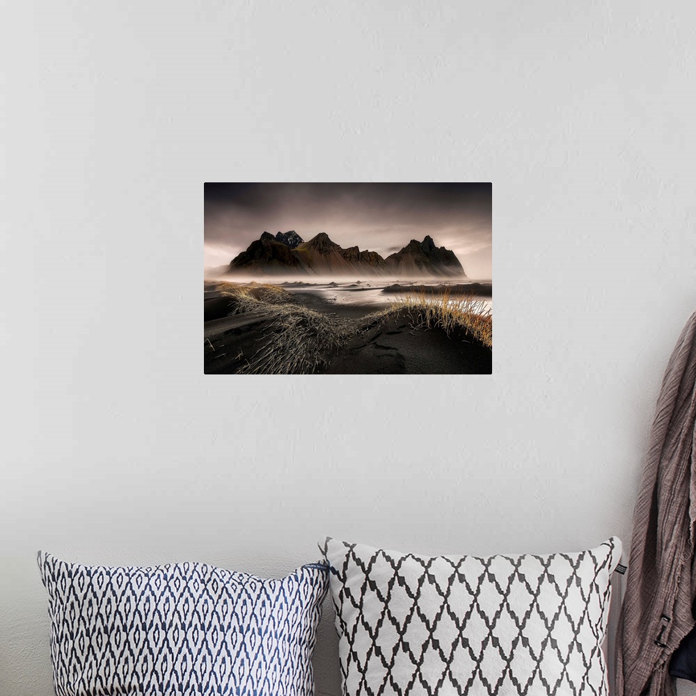A bohemian room featuring A jagged mountain range in a black sand valley in Iceland.