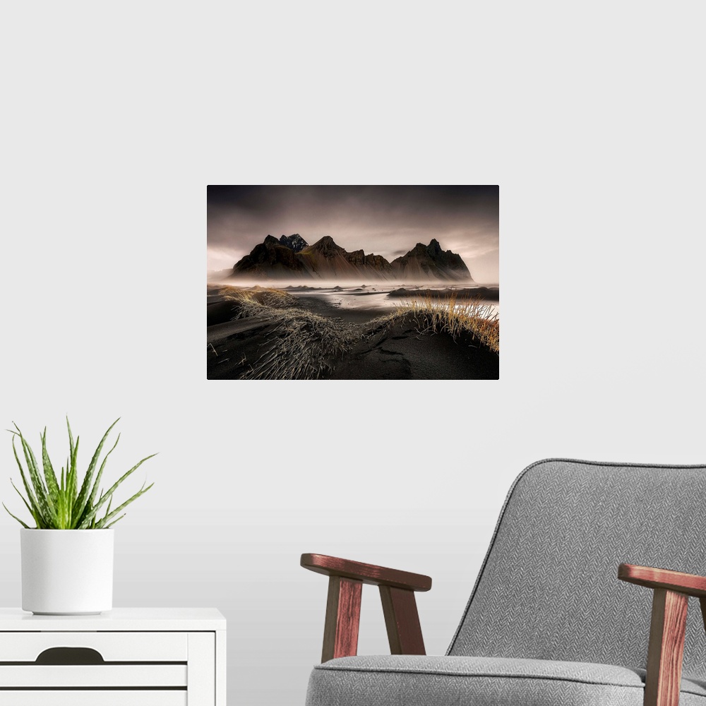 A modern room featuring A jagged mountain range in a black sand valley in Iceland.
