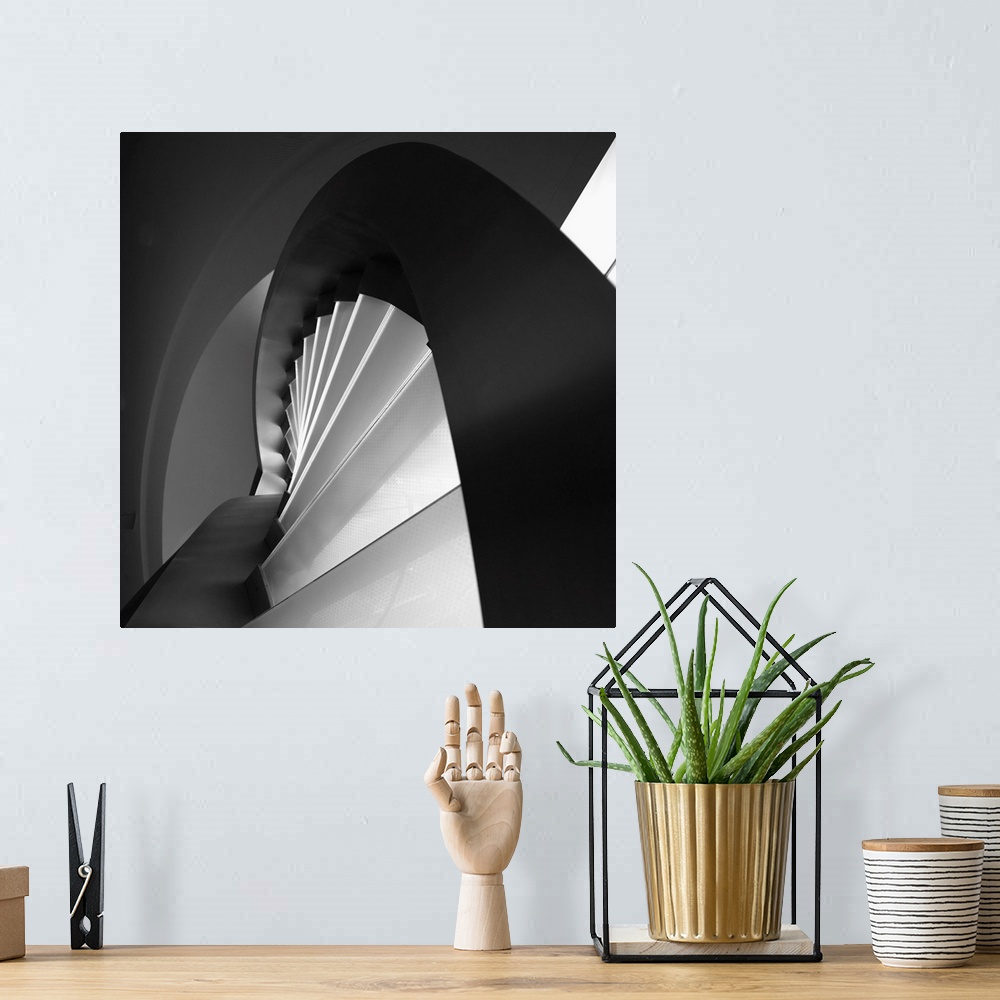 A bohemian room featuring A black and white photograph of an abstract view of architectural design.