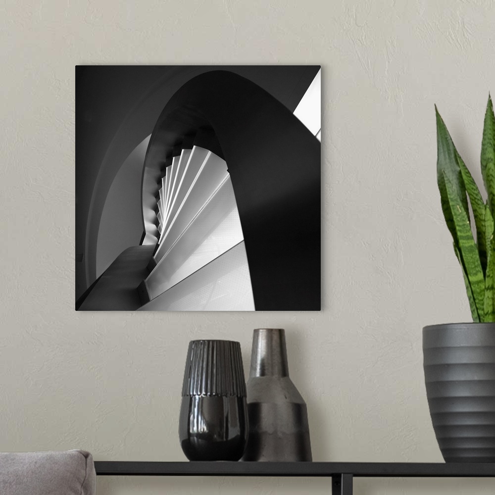 A modern room featuring A black and white photograph of an abstract view of architectural design.