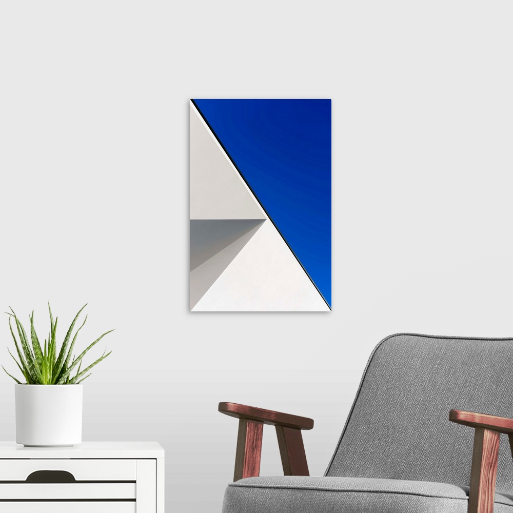A modern room featuring Side of a white building against a blue sky, creating an astract geometric image.