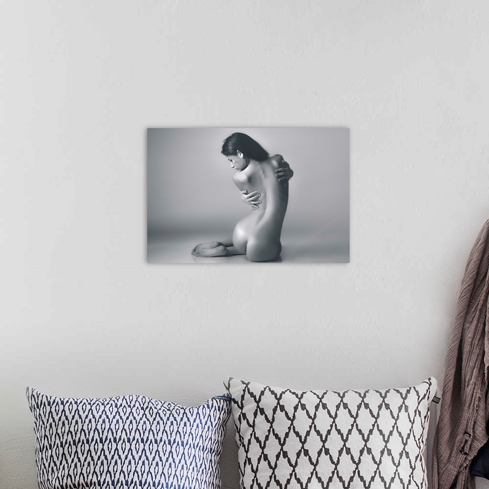 A bohemian room featuring A photograph of a nude female study.