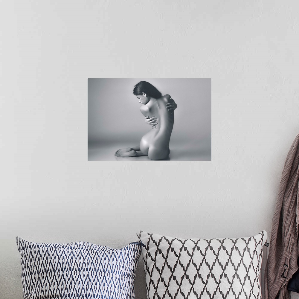 A bohemian room featuring A photograph of a nude female study.