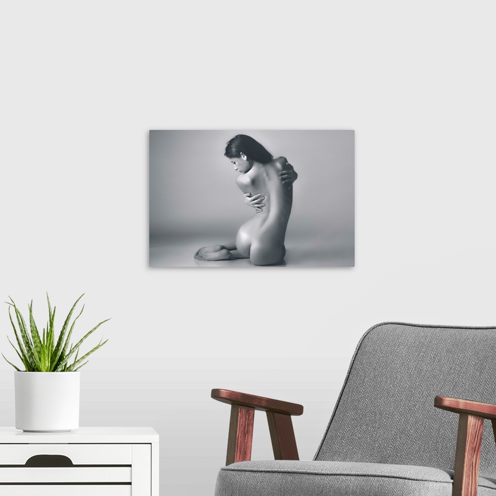 A modern room featuring A photograph of a nude female study.