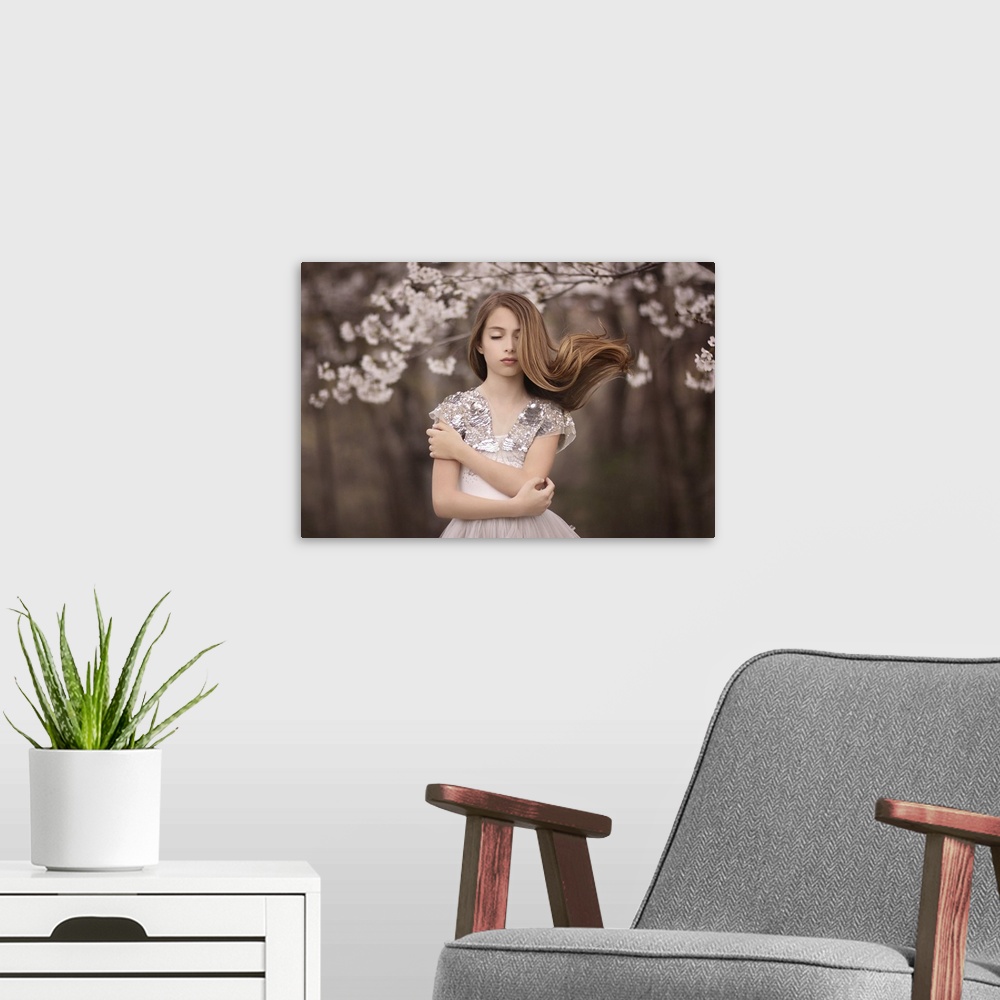 A modern room featuring Portrait of a beautiful young woman with long hair and a pastel pink dress.