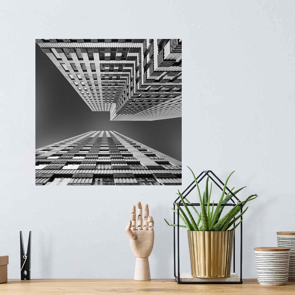 A bohemian room featuring Black and white image of skyscrapers seen from the ground, creating an abstract image.