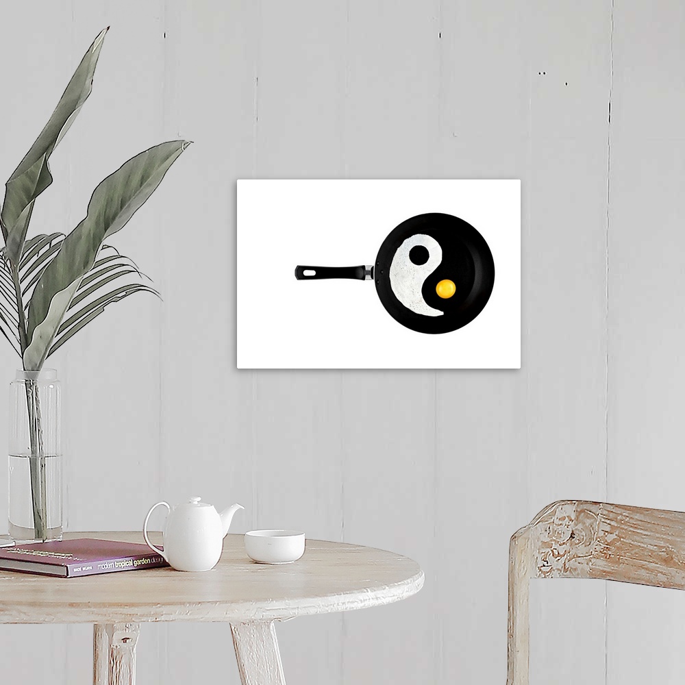 A farmhouse room featuring A frying pan with an eggwhite and yolk separated to resemble a yin yang symbol.