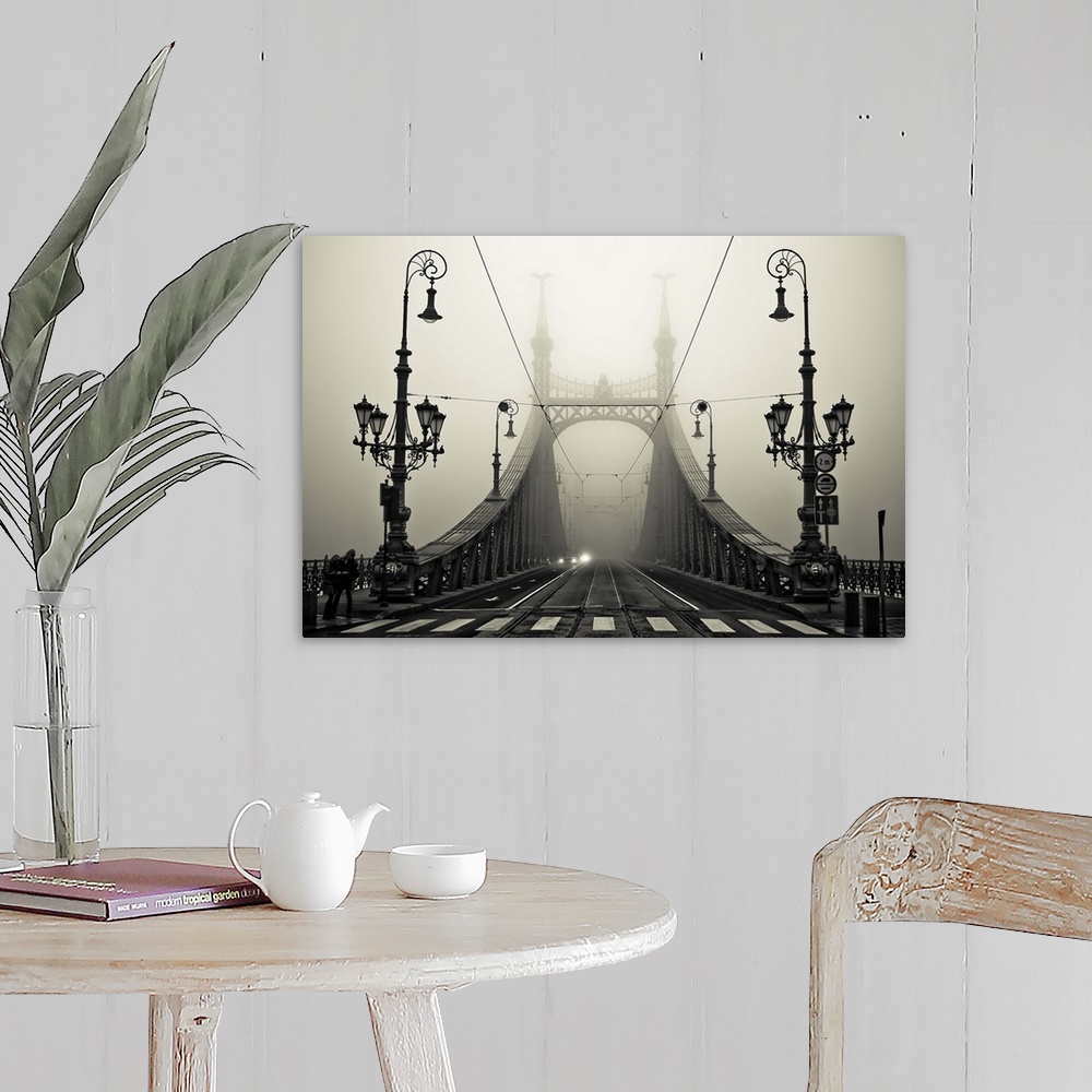 A farmhouse room featuring Ornate iron street lamps stand at the entrance to a bridge in Budapest, Hungary.