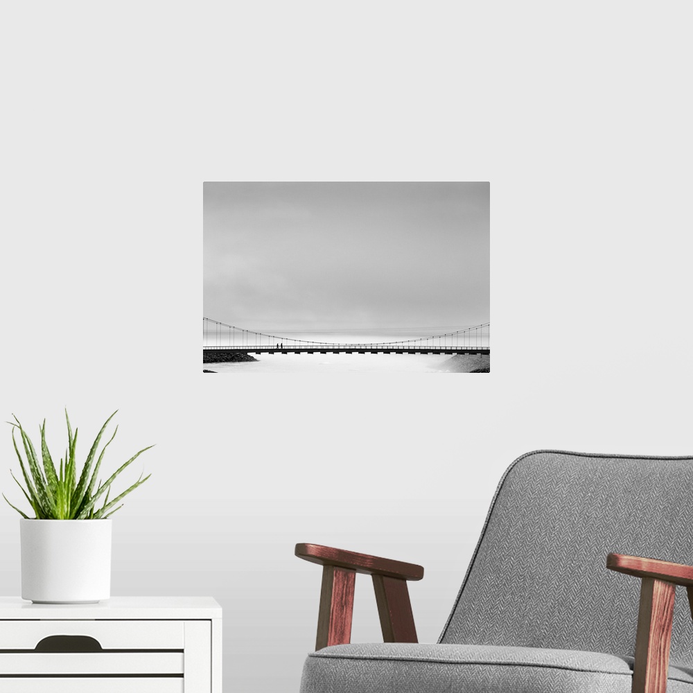 A modern room featuring Black and white image of a bridge spanning the mists, Iceland.