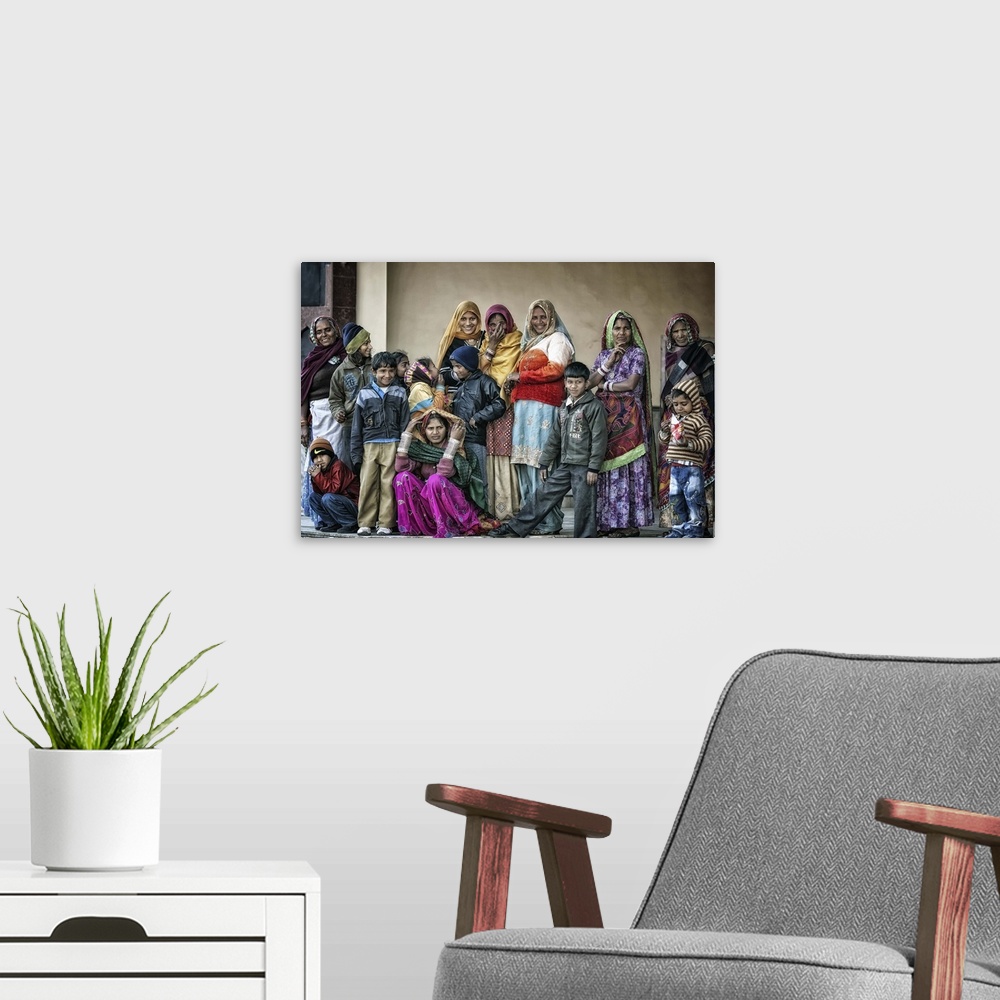 A modern room featuring A group of Indian people wearing colorful robes.