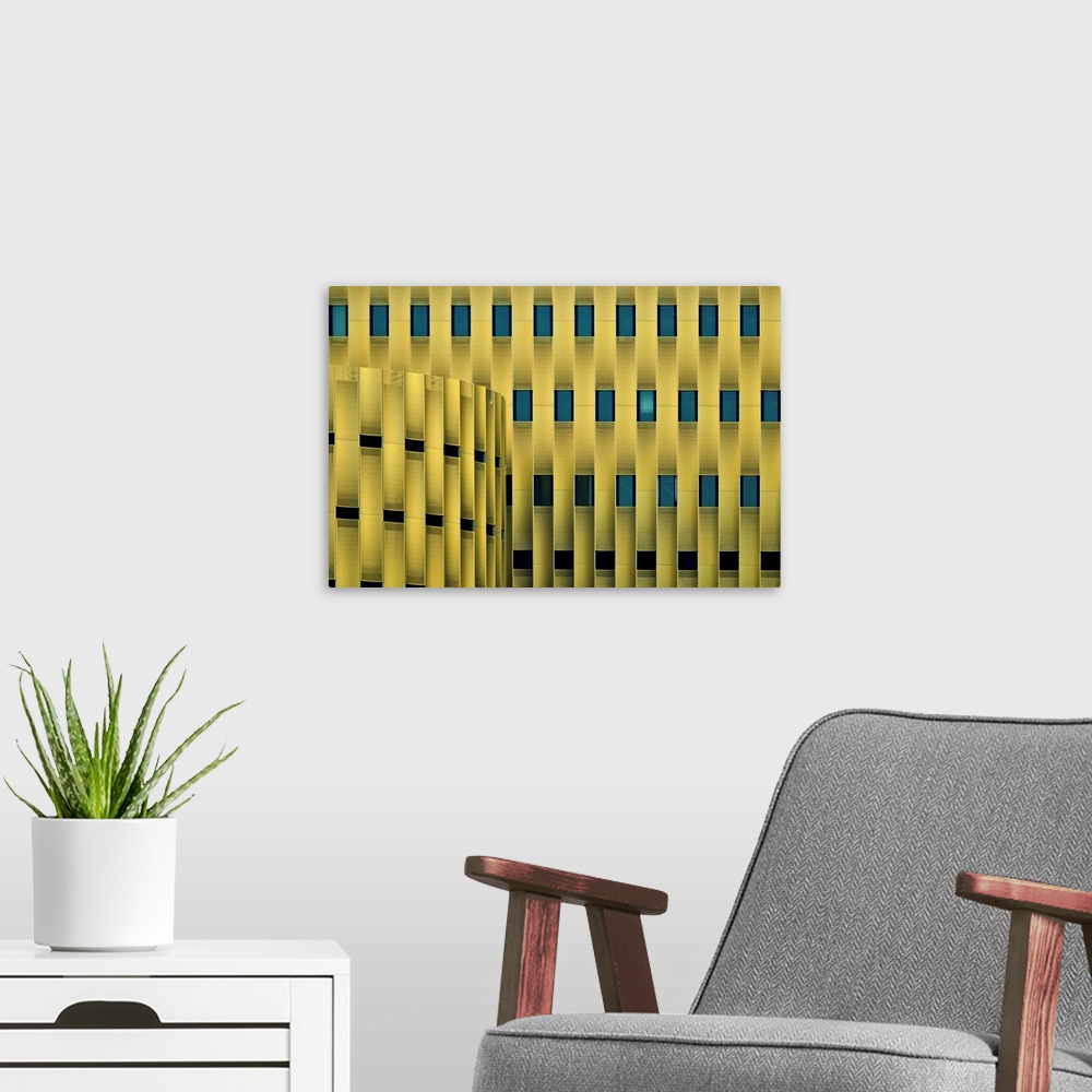 A modern room featuring Facade of a yellow building with repeating blue windows, forming an abstract pattern.